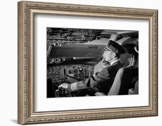 1960s AIRPLANE PILOT HAND ON CONTROLS IN COCKPIT OF AIRLINE AIRCRAFT-H. Armstrong Roberts-Framed Photographic Print