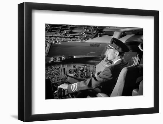 1960s AIRPLANE PILOT HAND ON CONTROLS IN COCKPIT OF AIRLINE AIRCRAFT-H. Armstrong Roberts-Framed Photographic Print