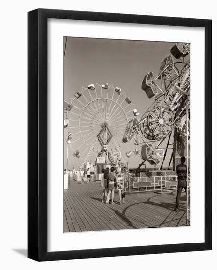 1960s Group of Teens Looking at Amusement Rides on Pier-null-Framed Photographic Print