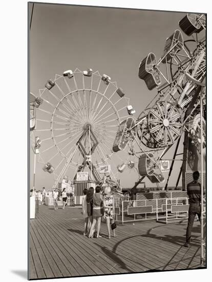 1960s Group of Teens Looking at Amusement Rides on Pier-null-Mounted Photographic Print
