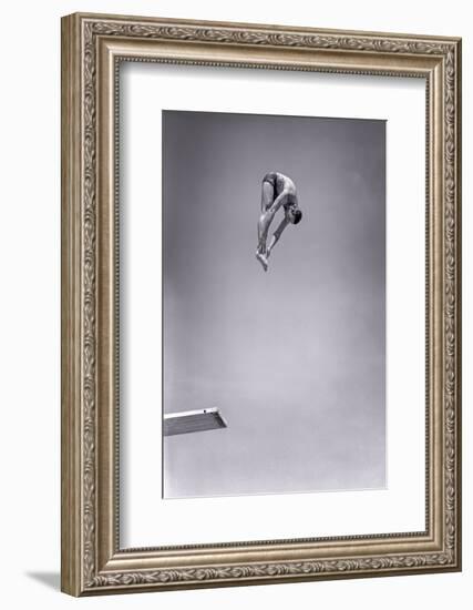 1960s MAN JUMPING OFF DIVING BOARD TOUCHING TOES DOING FORWARD DIVE IN THE PIKE POSITION-H. Armstrong Roberts-Framed Photographic Print