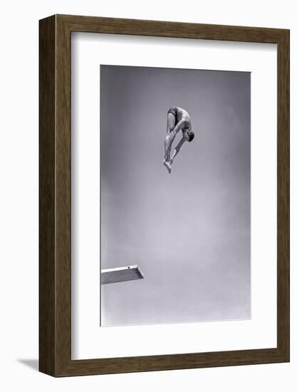 1960s MAN JUMPING OFF DIVING BOARD TOUCHING TOES DOING FORWARD DIVE IN THE PIKE POSITION-H. Armstrong Roberts-Framed Photographic Print