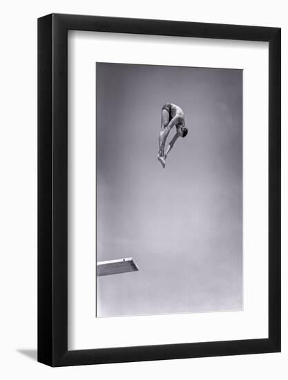 1960s MAN JUMPING OFF DIVING BOARD TOUCHING TOES DOING FORWARD DIVE IN THE PIKE POSITION-H. Armstrong Roberts-Framed Photographic Print