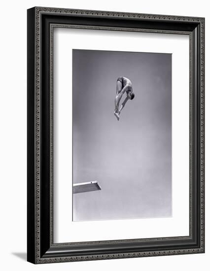 1960s MAN JUMPING OFF DIVING BOARD TOUCHING TOES DOING FORWARD DIVE IN THE PIKE POSITION-H. Armstrong Roberts-Framed Photographic Print