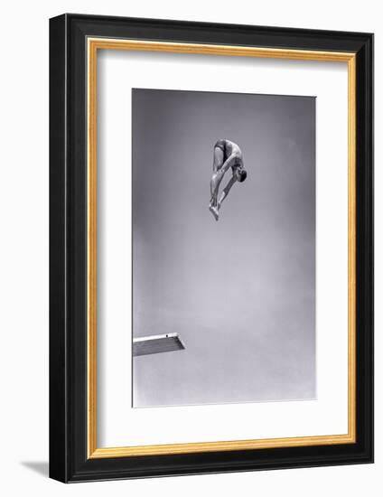 1960s MAN JUMPING OFF DIVING BOARD TOUCHING TOES DOING FORWARD DIVE IN THE PIKE POSITION-H. Armstrong Roberts-Framed Photographic Print