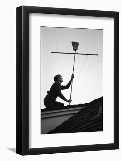 1967: Man Using a Broom to Improve the Antennae Reception During the Broadcast of Super Bowl I-Bill Ray-Framed Photographic Print