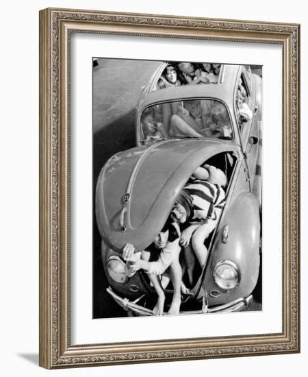 31 Teenagers Stuffed into a Volkswagen Beetle-null-Framed Photo