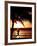 A Afternoon Runner Passes Under a Palm Tree as the Sun Sets Behind-null-Framed Photographic Print