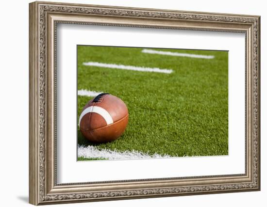 A American Football on a Green Football Field-flippo-Framed Photographic Print