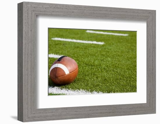 A American Football on a Green Football Field-flippo-Framed Photographic Print