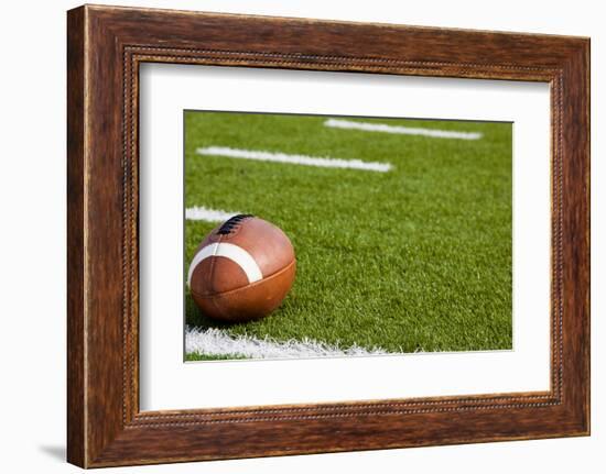 A American Football on a Green Football Field-flippo-Framed Photographic Print