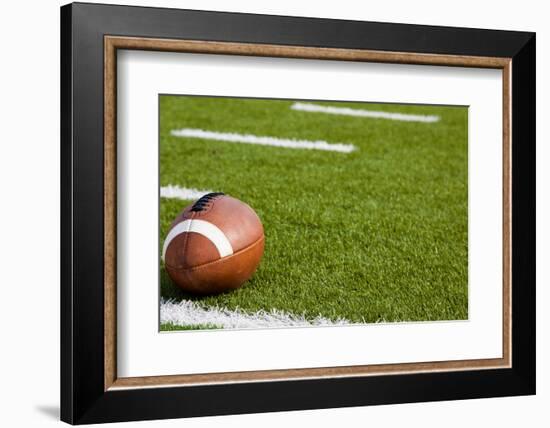 A American Football on a Green Football Field-flippo-Framed Photographic Print