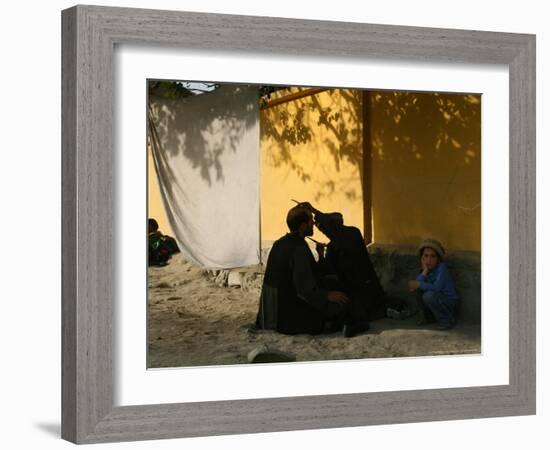 A Barber Cuts the Beard of a Client in His Barber Post in Kabul, Afghanistan, October 1, 2006-Rodrigo Abd-Framed Photographic Print