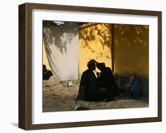 A Barber Cuts the Beard of a Client in His Barber Post in Kabul, Afghanistan, October 1, 2006-Rodrigo Abd-Framed Photographic Print