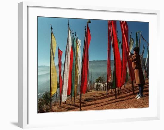 A Bhutanese Man Straightens a Prayer Flag at a Buddhist Shrine-null-Framed Photographic Print