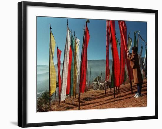 A Bhutanese Man Straightens a Prayer Flag at a Buddhist Shrine-null-Framed Photographic Print