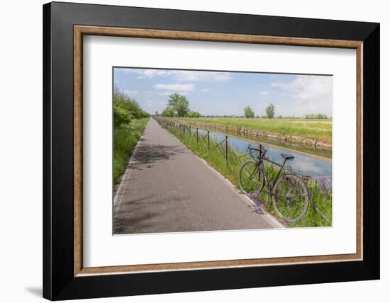 A bike on the rail of the Naviglio Pavense canal which links Milan to Pavia which has been transfor-Alexandre Rotenberg-Framed Photographic Print