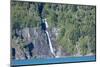 A boat in front of a waterfall on Puelo Lake in the Tagua Tagua reserve, Patagonia, Chile, South Am-Alex Robinson-Mounted Photographic Print