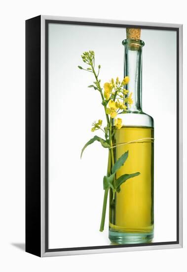 A Bottle of Rapeseed Oil with Flowers-Bodo A^ Schieren-Framed Premier Image Canvas