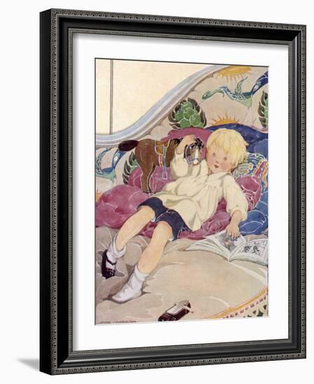 A Boy Lying on a Bed with a Book and a Toy Horse-Anne Anderson-Framed Art Print