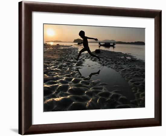 A Boy Plays on the Banks of the River Brahmaputra in Gauhati, India, Friday, October 27, 2006-Anupam Nath-Framed Photographic Print