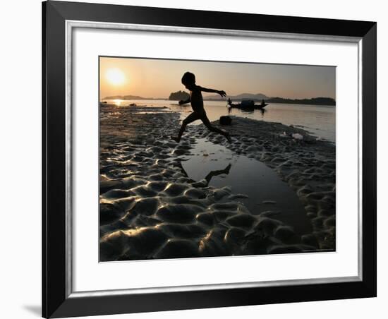 A Boy Plays on the Banks of the River Brahmaputra in Gauhati, India, Friday, October 27, 2006-Anupam Nath-Framed Photographic Print