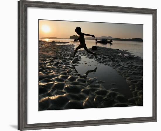 A Boy Plays on the Banks of the River Brahmaputra in Gauhati, India, Friday, October 27, 2006-Anupam Nath-Framed Photographic Print