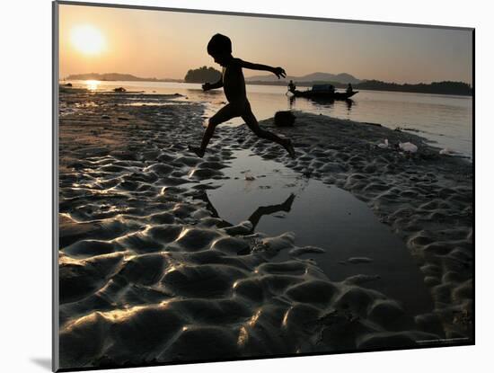 A Boy Plays on the Banks of the River Brahmaputra in Gauhati, India, Friday, October 27, 2006-Anupam Nath-Mounted Photographic Print
