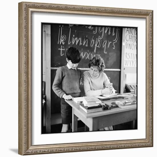 A Boy Pupil Reading with His Teacher, at Her Desk in Front of the Blackboard-Henry Grant-Framed Photographic Print