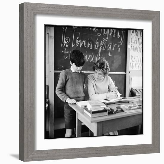 A Boy Pupil Reading with His Teacher, at Her Desk in Front of the Blackboard-Henry Grant-Framed Photographic Print