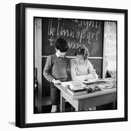 A Boy Pupil Reading with His Teacher, at Her Desk in Front of the Blackboard-Henry Grant-Framed Photographic Print