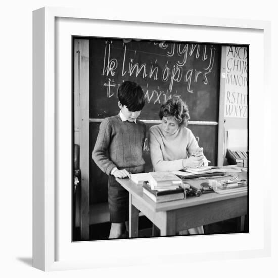 A Boy Pupil Reading with His Teacher, at Her Desk in Front of the Blackboard-Henry Grant-Framed Photographic Print