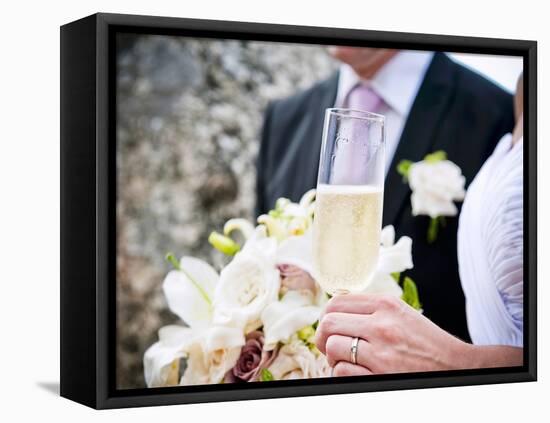 A Bride and Groom with a Glass of Champagne and a Bouquet-null-Framed Premier Image Canvas