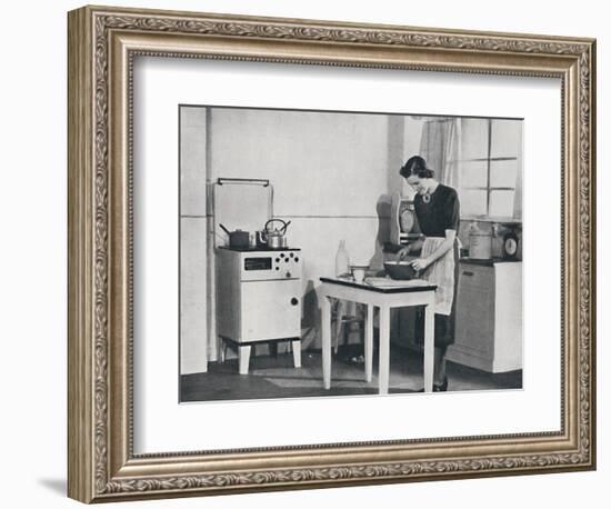 'A British kitchen equipped with a cabinet gas cooker', 1942-Unknown-Framed Photographic Print