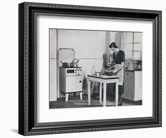 'A British kitchen equipped with a cabinet gas cooker', 1942-Unknown-Framed Photographic Print