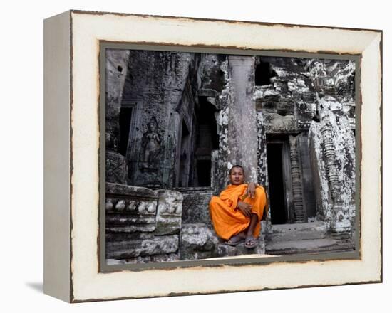 A Buddhist Monk Relaxes in the Bayon Temple, Angkor, Unesco World Heritage Site, Cambodia-Andrew Mcconnell-Framed Premier Image Canvas