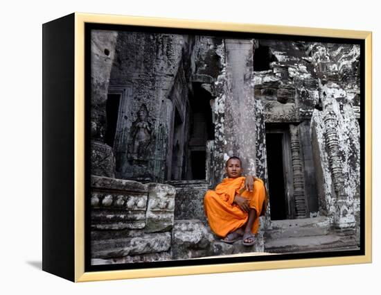 A Buddhist Monk Relaxes in the Bayon Temple, Angkor, Unesco World Heritage Site, Cambodia-Andrew Mcconnell-Framed Premier Image Canvas