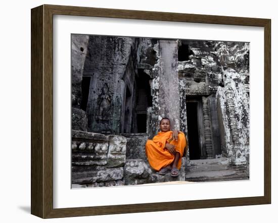 A Buddhist Monk Relaxes in the Bayon Temple, Angkor, Unesco World Heritage Site, Cambodia-Andrew Mcconnell-Framed Photographic Print