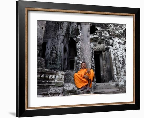 A Buddhist Monk Relaxes in the Bayon Temple, Angkor, Unesco World Heritage Site, Cambodia-Andrew Mcconnell-Framed Photographic Print