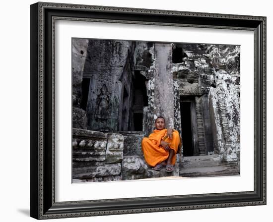 A Buddhist Monk Relaxes in the Bayon Temple, Angkor, Unesco World Heritage Site, Cambodia-Andrew Mcconnell-Framed Photographic Print