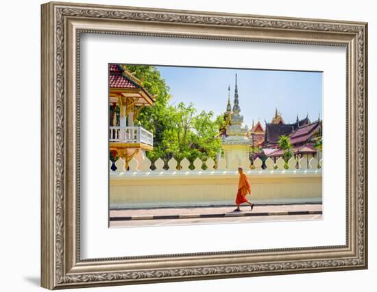 A buddhist monk walks past Wat Si Saket (Wat Sisaket) temple in central Vientiane, Laos-Jason Langley-Framed Photographic Print