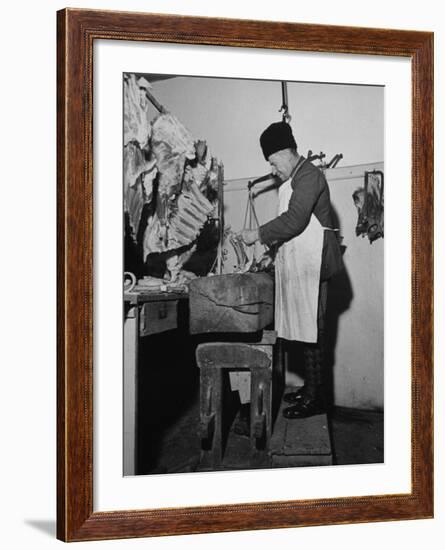 A Butcher Working in the Hungarian Meat Shop-John Phillips-Framed Premium Photographic Print