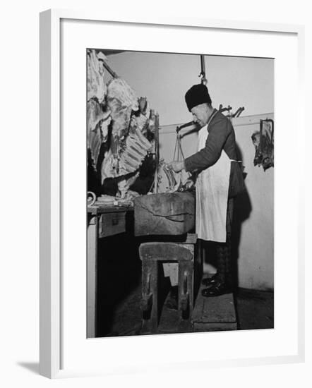 A Butcher Working in the Hungarian Meat Shop-John Phillips-Framed Premium Photographic Print