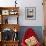 A Cat Joins its Owner Reading a Book at a Tokyo Cafe-null-Framed Photographic Print displayed on a wall