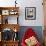 A Cat Joins its Owner Reading a Book at a Tokyo Cafe-null-Framed Photographic Print displayed on a wall