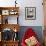 A Cat Joins its Owner Reading a Book at a Tokyo Cafe-null-Framed Photographic Print displayed on a wall