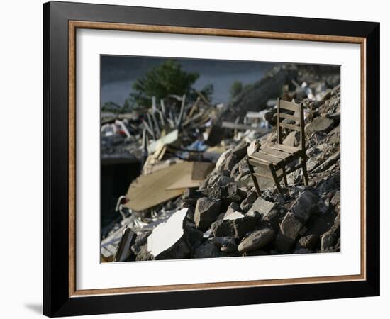 A Chair is Seen on the Rubble of a Collapsed Apartment Complex-null-Framed Photographic Print