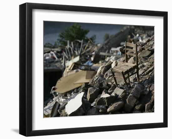 A Chair is Seen on the Rubble of a Collapsed Apartment Complex-null-Framed Photographic Print