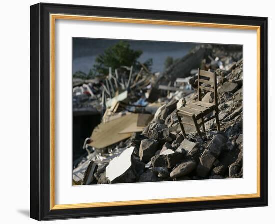 A Chair is Seen on the Rubble of a Collapsed Apartment Complex-null-Framed Photographic Print