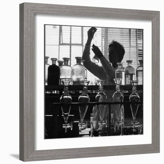 A Chemist at Work in Her Laboratory-Henry Grant-Framed Photographic Print